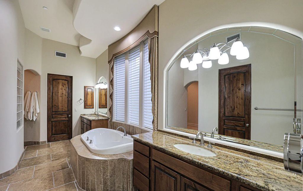 The Home in Scottsdale, a custom estate sitting on 2.78 acres in gated Sonoran Crest with details including box-beam, coffered and groin vault ceiling details, travertine stone flooring, granite counter surfaces, richly stained wood doors, trim, and cabinetry, a split floor plan and so much more is now available for sale. This home located at 24375 N 121st Pl, Scottsdale, Arizona