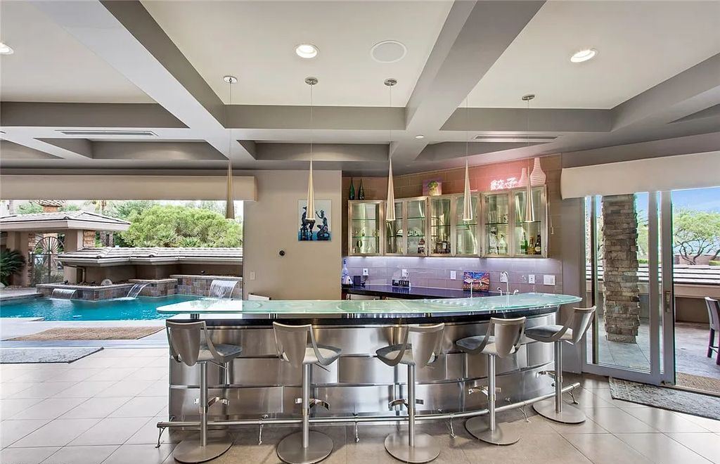 The Home in Henderson, an entirely custom & contemporary home offers views from every room, private courtyard with pool, spa, outdoor kitchen, fire pit and built-in BBQ, dual living rooms with fireplaces, motorized shades is now available for sale. This home located at 580 Saint Croix St, Henderson, Nevada