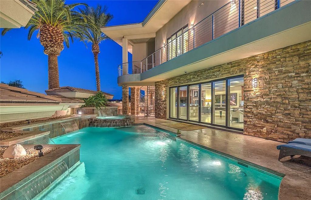 The Home in Henderson, an entirely custom & contemporary home offers views from every room, private courtyard with pool, spa, outdoor kitchen, fire pit and built-in BBQ, dual living rooms with fireplaces, motorized shades is now available for sale. This home located at 580 Saint Croix St, Henderson, Nevada