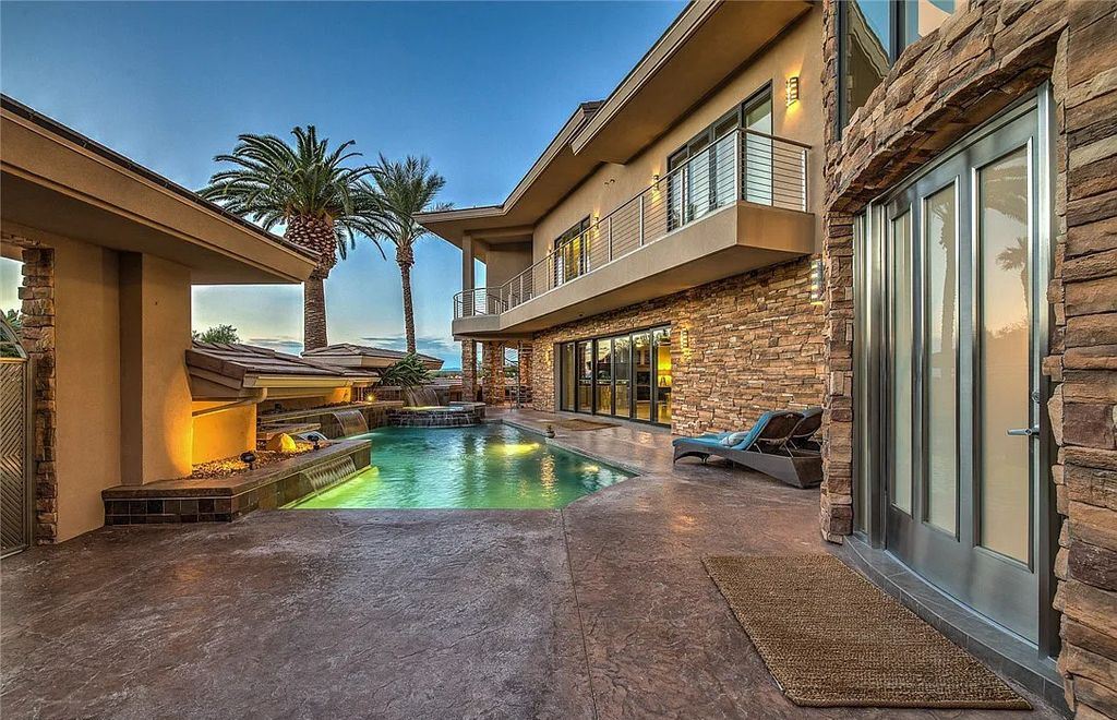 The Home in Henderson, an entirely custom & contemporary home offers views from every room, private courtyard with pool, spa, outdoor kitchen, fire pit and built-in BBQ, dual living rooms with fireplaces, motorized shades is now available for sale. This home located at 580 Saint Croix St, Henderson, Nevada