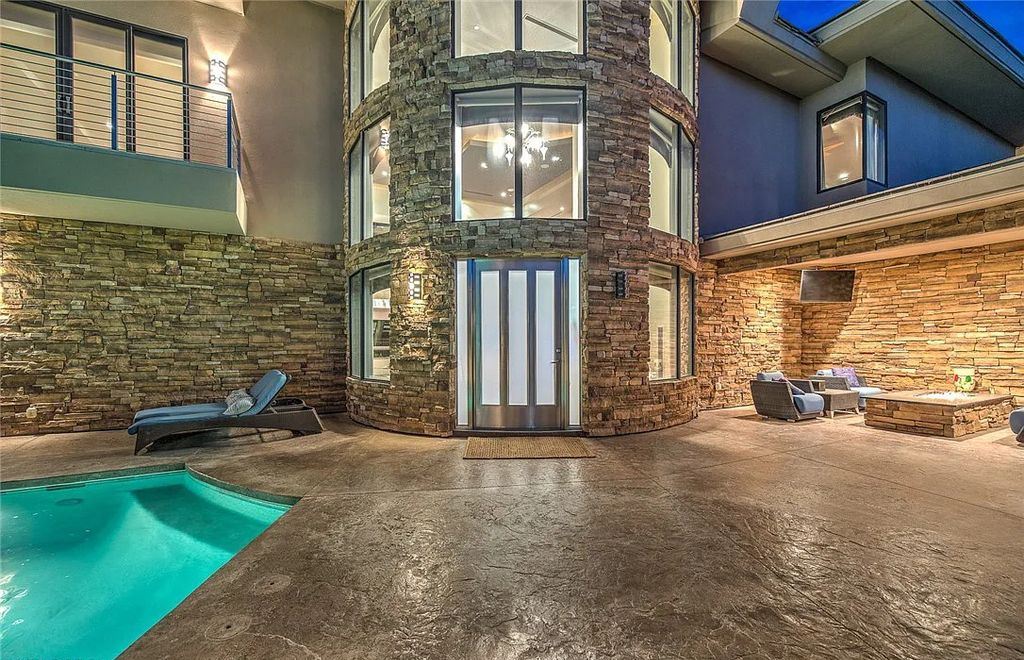 The Home in Henderson, an entirely custom & contemporary home offers views from every room, private courtyard with pool, spa, outdoor kitchen, fire pit and built-in BBQ, dual living rooms with fireplaces, motorized shades is now available for sale. This home located at 580 Saint Croix St, Henderson, Nevada