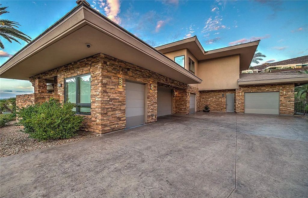 The Home in Henderson, an entirely custom & contemporary home offers views from every room, private courtyard with pool, spa, outdoor kitchen, fire pit and built-in BBQ, dual living rooms with fireplaces, motorized shades is now available for sale. This home located at 580 Saint Croix St, Henderson, Nevada