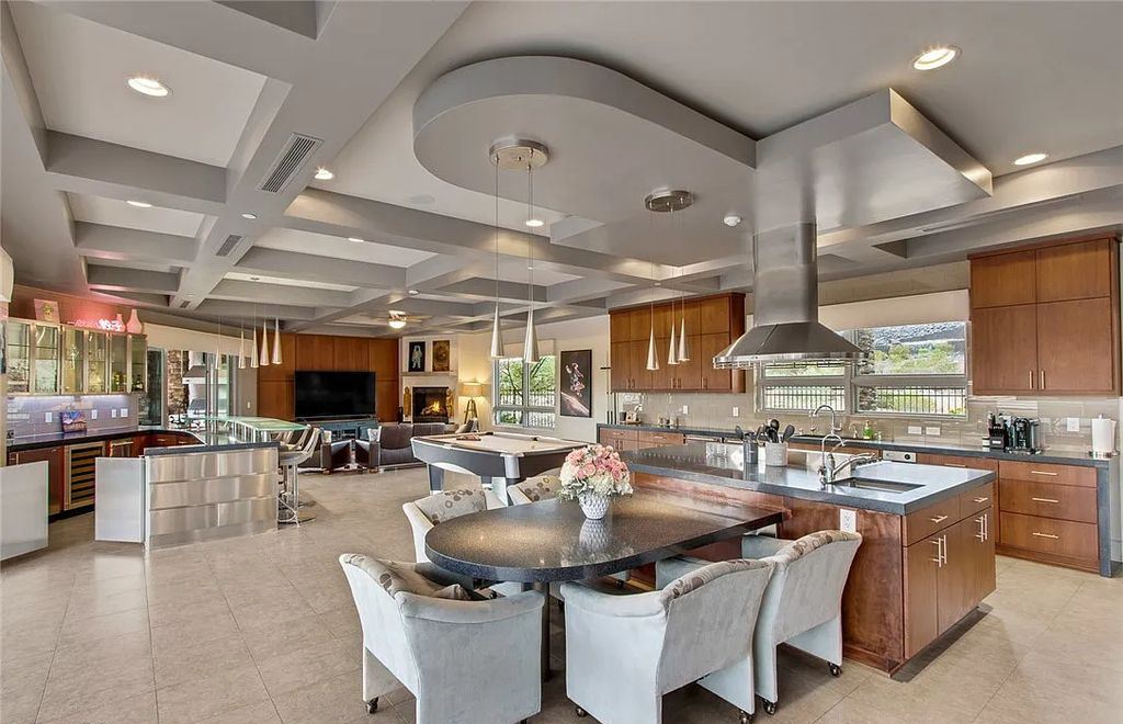 The Home in Henderson, an entirely custom & contemporary home offers views from every room, private courtyard with pool, spa, outdoor kitchen, fire pit and built-in BBQ, dual living rooms with fireplaces, motorized shades is now available for sale. This home located at 580 Saint Croix St, Henderson, Nevada