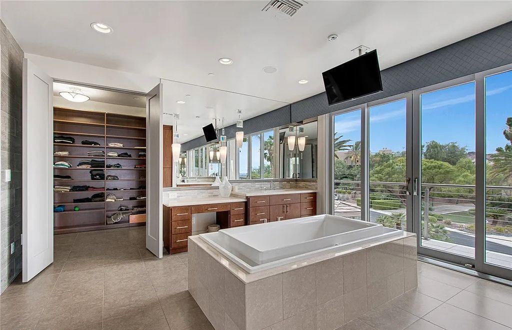 The Home in Henderson, an entirely custom & contemporary home offers views from every room, private courtyard with pool, spa, outdoor kitchen, fire pit and built-in BBQ, dual living rooms with fireplaces, motorized shades is now available for sale. This home located at 580 Saint Croix St, Henderson, Nevada