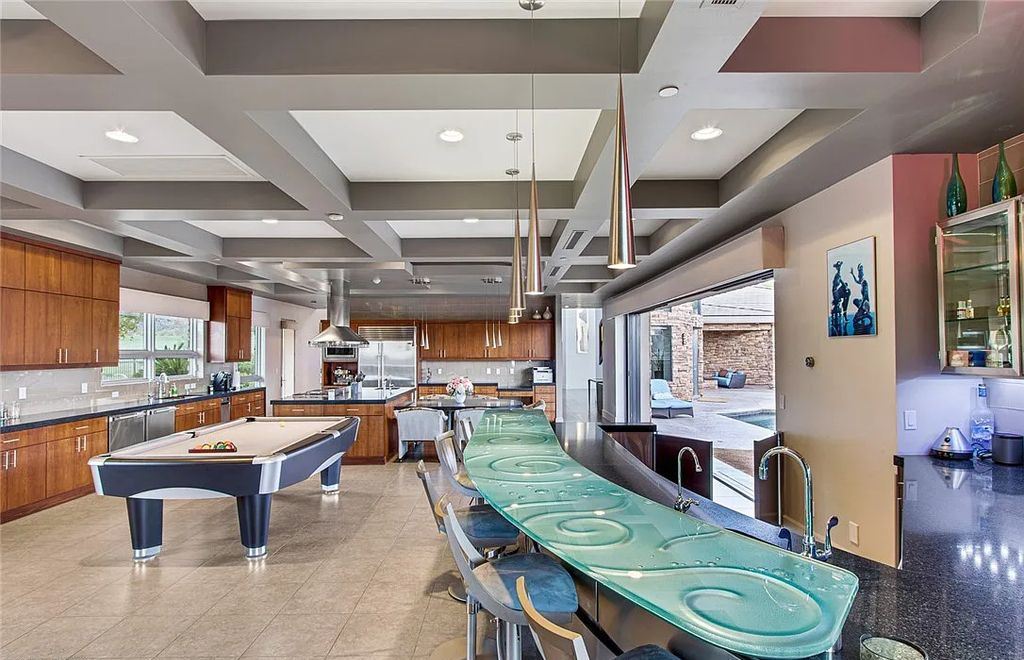 The Home in Henderson, an entirely custom & contemporary home offers views from every room, private courtyard with pool, spa, outdoor kitchen, fire pit and built-in BBQ, dual living rooms with fireplaces, motorized shades is now available for sale. This home located at 580 Saint Croix St, Henderson, Nevada