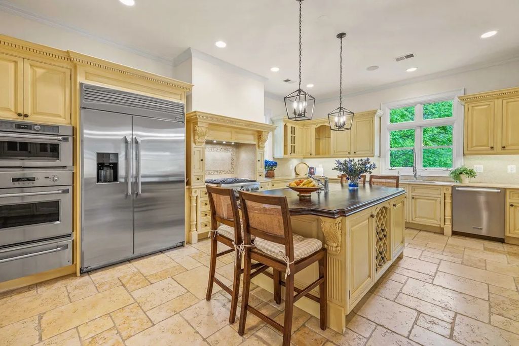 The Home in Bethesda features a private balcony seemingly floating in the woods, while an oversized walk-in closet and spa-inspired bath with separate vanities, now available for sale. This home located at 8814 Chalon Dr, Bethesda, Maryland