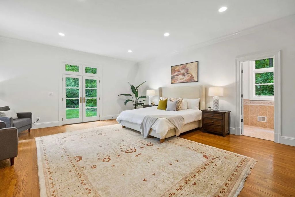 The Home in Bethesda features a private balcony seemingly floating in the woods, while an oversized walk-in closet and spa-inspired bath with separate vanities, now available for sale. This home located at 8814 Chalon Dr, Bethesda, Maryland