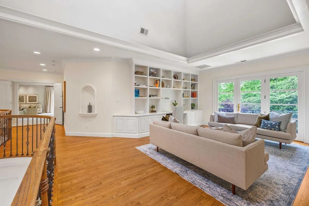The Home in Bethesda features a private balcony seemingly floating in the woods, while an oversized walk-in closet and spa-inspired bath with separate vanities, now available for sale. This home located at 8814 Chalon Dr, Bethesda, Maryland