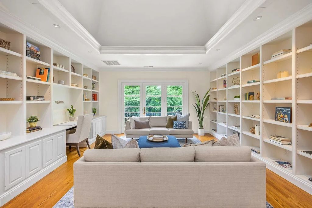 The Home in Bethesda features a private balcony seemingly floating in the woods, while an oversized walk-in closet and spa-inspired bath with separate vanities, now available for sale. This home located at 8814 Chalon Dr, Bethesda, Maryland
