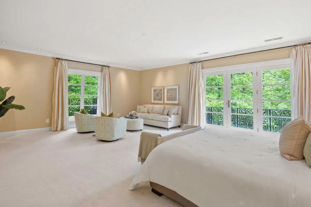 The Home in Bethesda features a private balcony seemingly floating in the woods, while an oversized walk-in closet and spa-inspired bath with separate vanities, now available for sale. This home located at 8814 Chalon Dr, Bethesda, Maryland