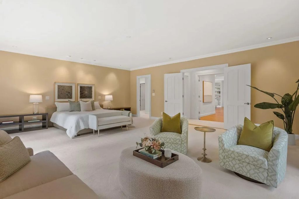The Home in Bethesda features a private balcony seemingly floating in the woods, while an oversized walk-in closet and spa-inspired bath with separate vanities, now available for sale. This home located at 8814 Chalon Dr, Bethesda, Maryland