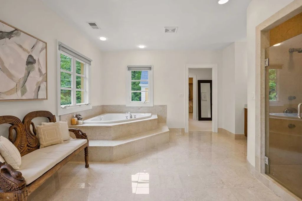 The Home in Bethesda features a private balcony seemingly floating in the woods, while an oversized walk-in closet and spa-inspired bath with separate vanities, now available for sale. This home located at 8814 Chalon Dr, Bethesda, Maryland