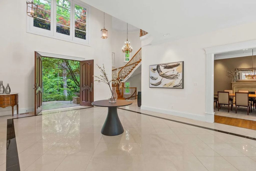 The Home in Bethesda features a private balcony seemingly floating in the woods, while an oversized walk-in closet and spa-inspired bath with separate vanities, now available for sale. This home located at 8814 Chalon Dr, Bethesda, Maryland