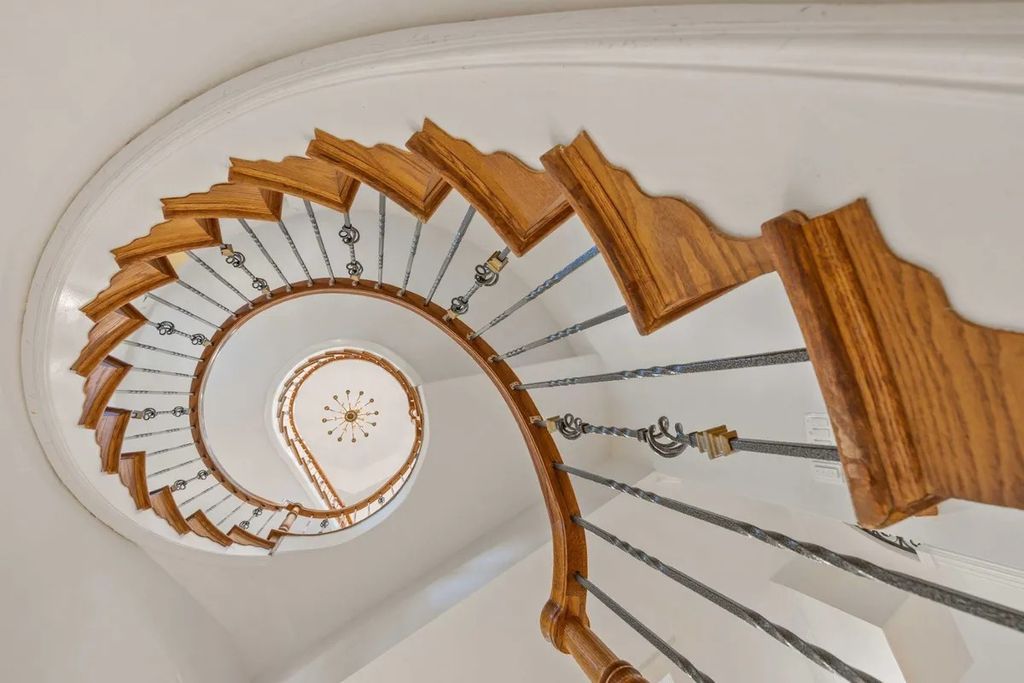 The Home in Bethesda features a private balcony seemingly floating in the woods, while an oversized walk-in closet and spa-inspired bath with separate vanities, now available for sale. This home located at 8814 Chalon Dr, Bethesda, Maryland