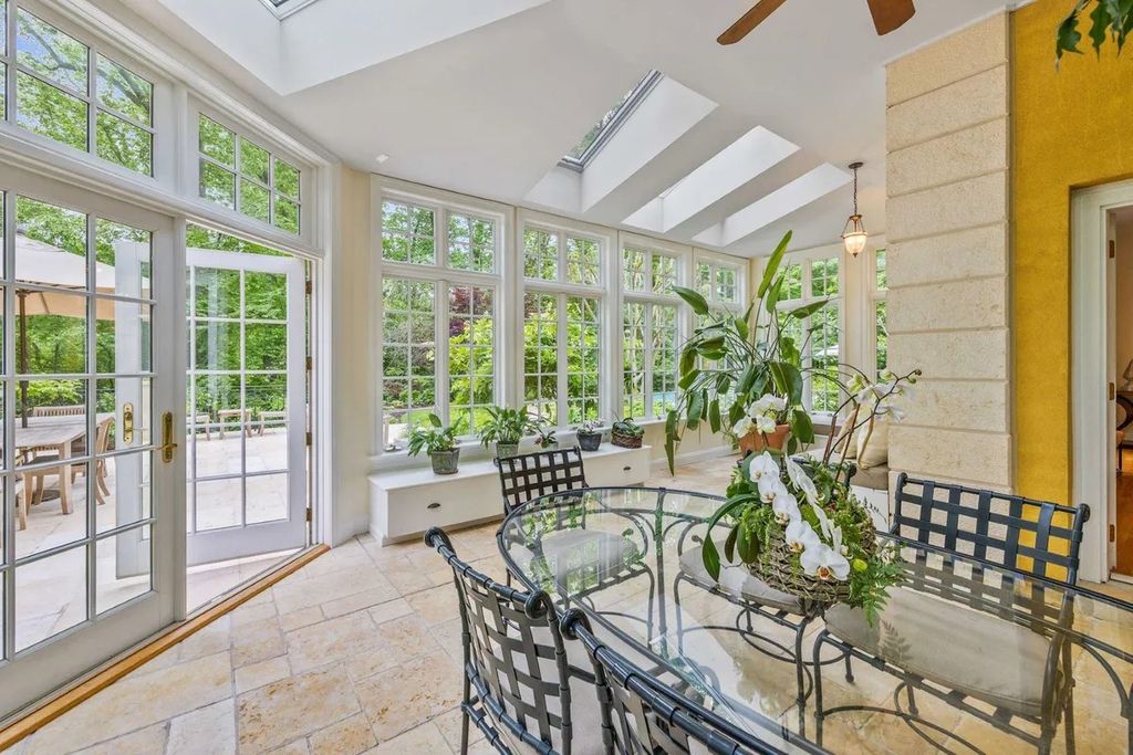 The Home in Bethesda features a private balcony seemingly floating in the woods, while an oversized walk-in closet and spa-inspired bath with separate vanities, now available for sale. This home located at 8814 Chalon Dr, Bethesda, Maryland