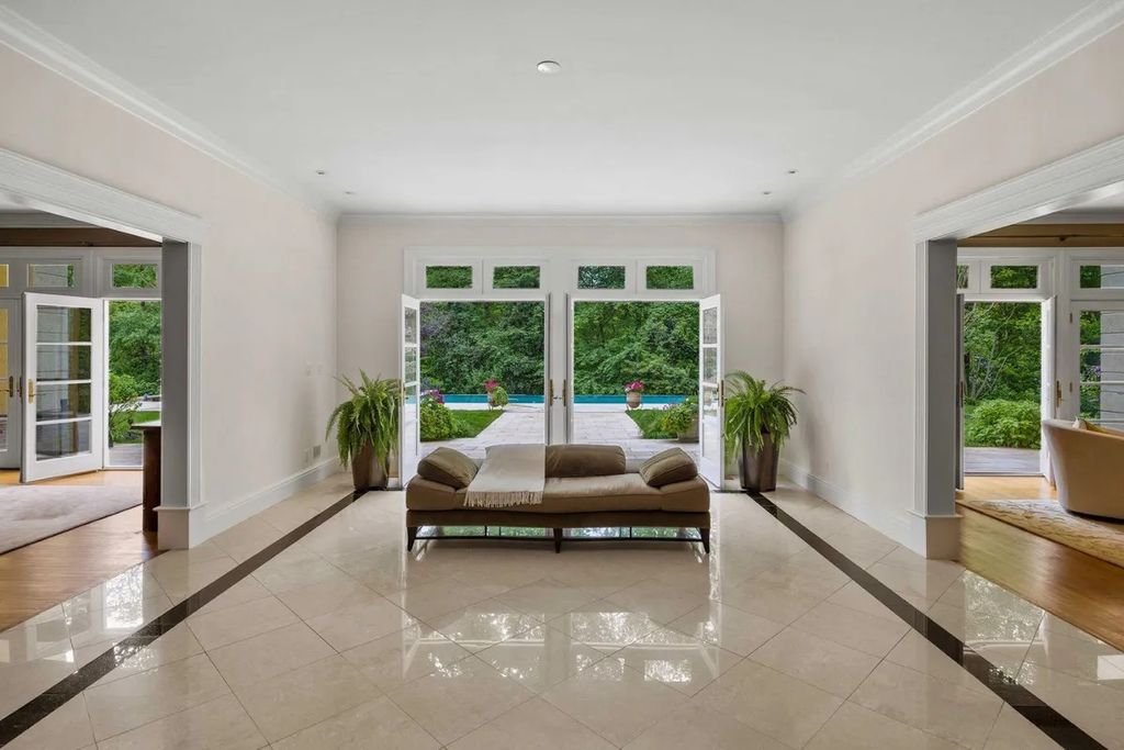 The Home in Bethesda features a private balcony seemingly floating in the woods, while an oversized walk-in closet and spa-inspired bath with separate vanities, now available for sale. This home located at 8814 Chalon Dr, Bethesda, Maryland