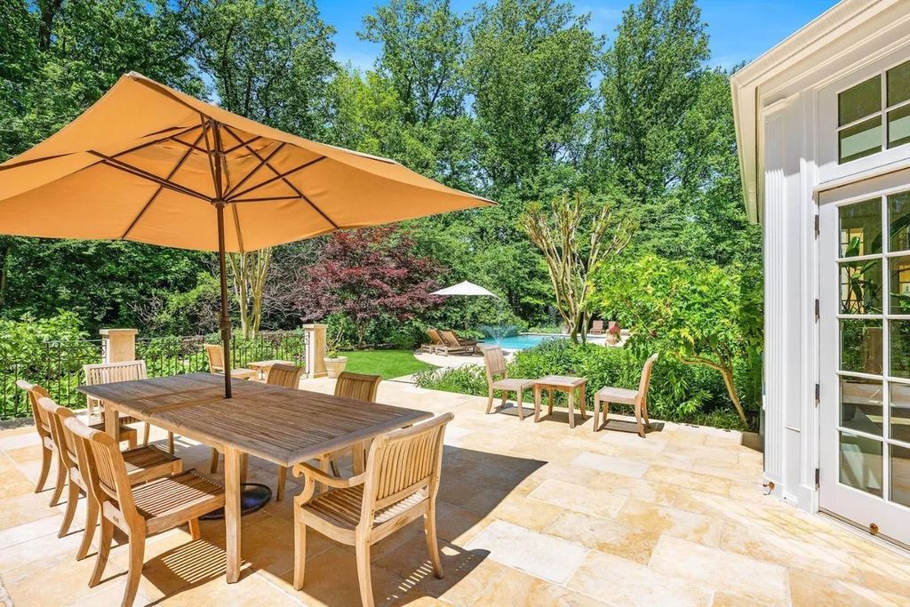 The Home in Bethesda features a private balcony seemingly floating in the woods, while an oversized walk-in closet and spa-inspired bath with separate vanities, now available for sale. This home located at 8814 Chalon Dr, Bethesda, Maryland