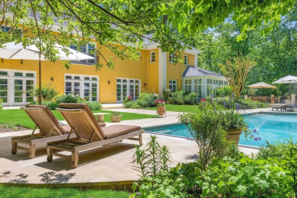 The Home in Bethesda features a private balcony seemingly floating in the woods, while an oversized walk-in closet and spa-inspired bath with separate vanities, now available for sale. This home located at 8814 Chalon Dr, Bethesda, Maryland
