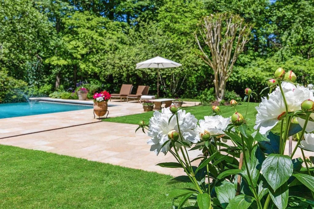 The Home in Bethesda features a private balcony seemingly floating in the woods, while an oversized walk-in closet and spa-inspired bath with separate vanities, now available for sale. This home located at 8814 Chalon Dr, Bethesda, Maryland