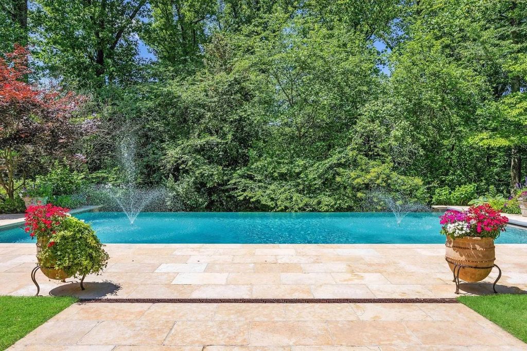 The Home in Bethesda features a private balcony seemingly floating in the woods, while an oversized walk-in closet and spa-inspired bath with separate vanities, now available for sale. This home located at 8814 Chalon Dr, Bethesda, Maryland