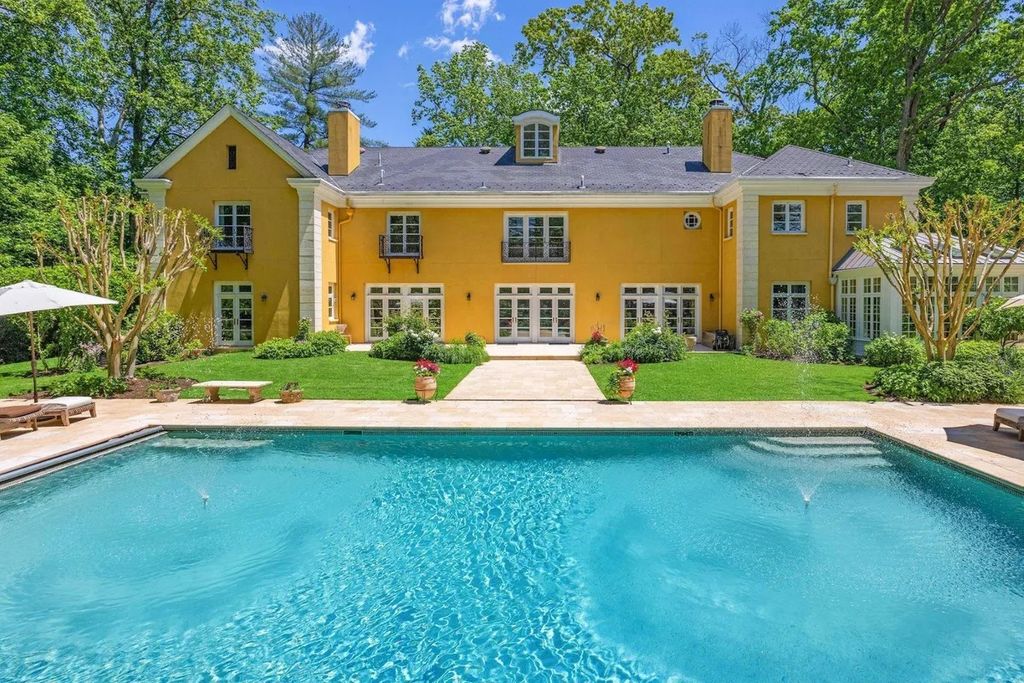 The Home in Bethesda features a private balcony seemingly floating in the woods, while an oversized walk-in closet and spa-inspired bath with separate vanities, now available for sale. This home located at 8814 Chalon Dr, Bethesda, Maryland