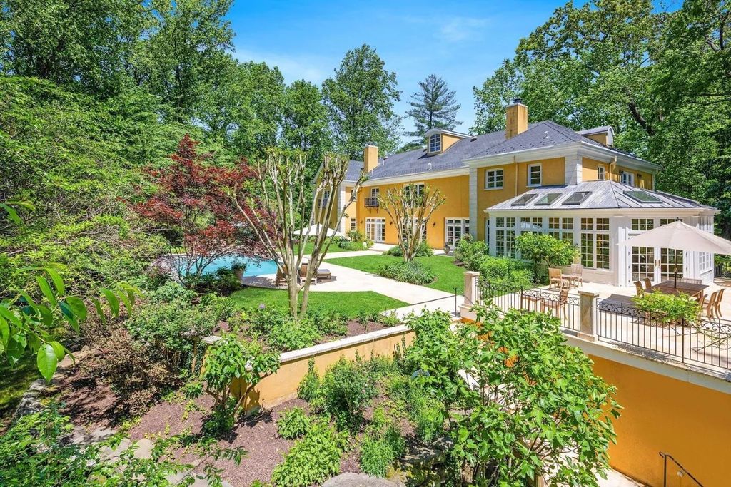 The Home in Bethesda features a private balcony seemingly floating in the woods, while an oversized walk-in closet and spa-inspired bath with separate vanities, now available for sale. This home located at 8814 Chalon Dr, Bethesda, Maryland