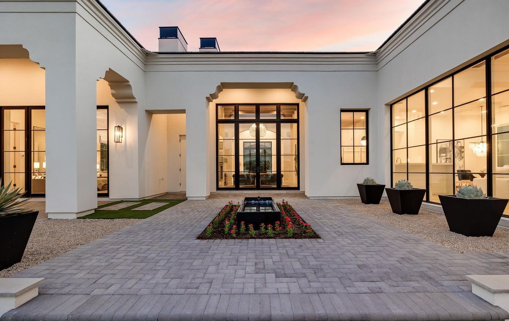 8311 N 53rd Street, Paradise Valley, Arizona is a transitional Mediterranean estate with amazing Mummy mountain views and tons of privacy showcases the pinnacle of resort style living. 