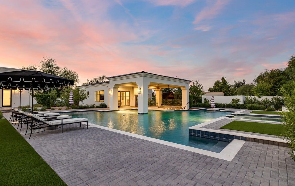 8311 N 53rd Street, Paradise Valley, Arizona is a transitional Mediterranean estate with amazing Mummy mountain views and tons of privacy showcases the pinnacle of resort style living. 