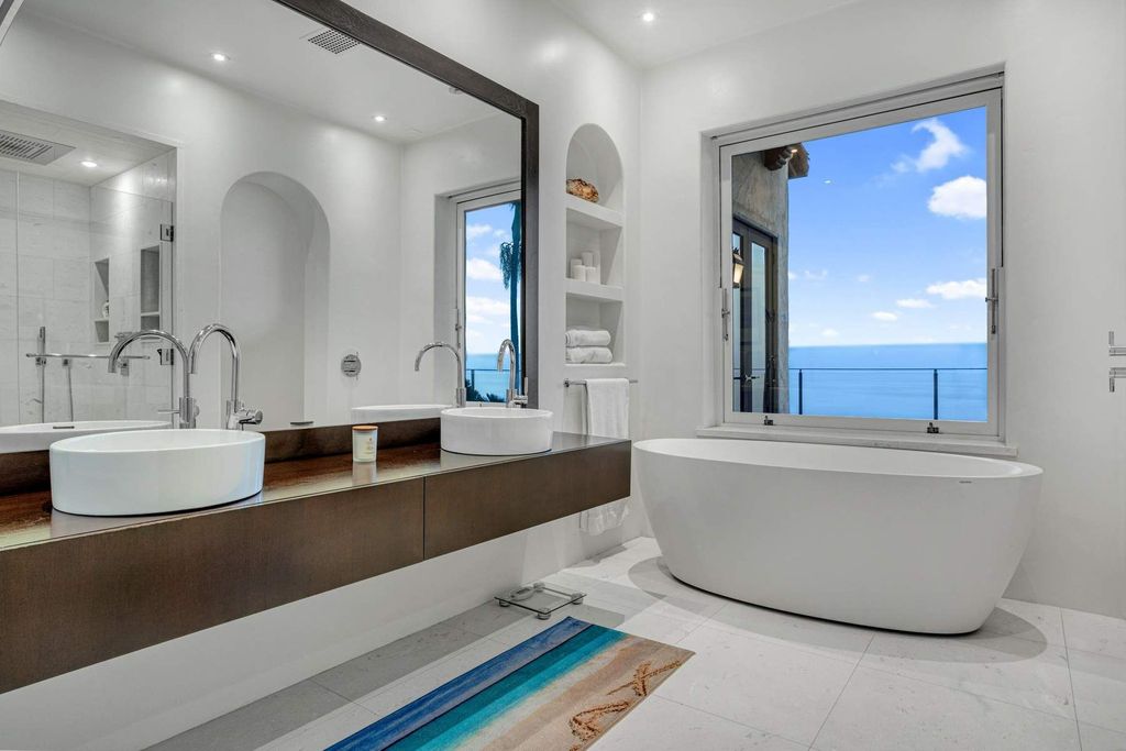 The Estate in Malibu, an exceptional property on the bluffs of the world-renowned Paradise Cove Beach offers destination resort-style living with a gorgeous infinity pool, a tennis court, outdoor barbeque and pizza oven and more is now available for sale. This home located at 28060 Sea Lane Dr, Malibu, California