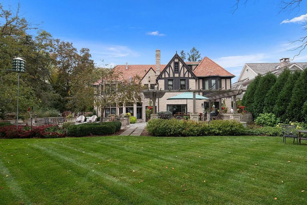 The Mansion in Shorewood offers beautiful backyard with outdoor granite Kit, pergola dining area and Firepit, now available for sale. This home located at 4496 North Lake Dr, Shorewood, Wisconsin