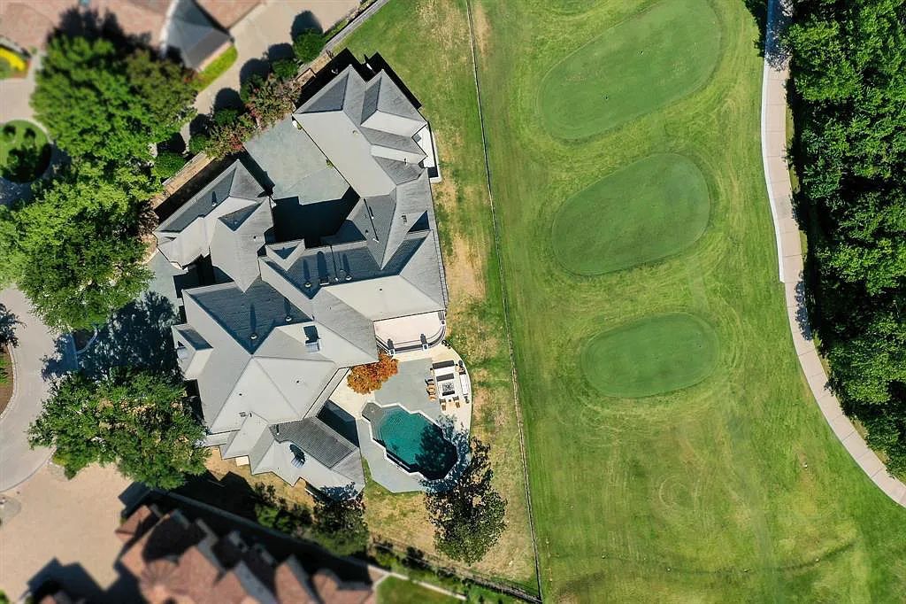 5801 Cypress Point Dr, Fort Worth, Texas is stunning remodeled estate in guarded and gated Mira Vista community on a cul-de-sac lot overlooking the 7th tee box, green and lake.