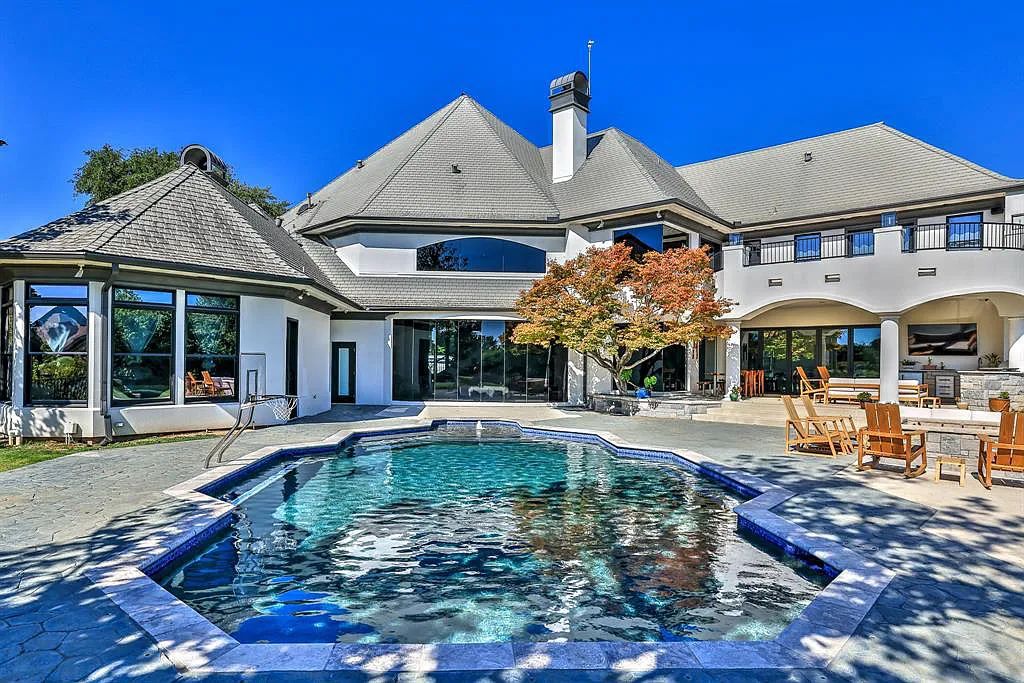 5801 Cypress Point Dr, Fort Worth, Texas is stunning remodeled estate in guarded and gated Mira Vista community on a cul-de-sac lot overlooking the 7th tee box, green and lake.