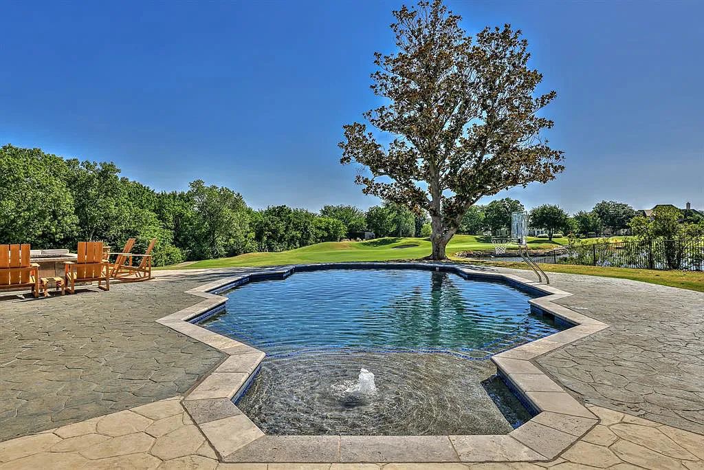 5801 Cypress Point Dr, Fort Worth, Texas is stunning remodeled estate in guarded and gated Mira Vista community on a cul-de-sac lot overlooking the 7th tee box, green and lake.