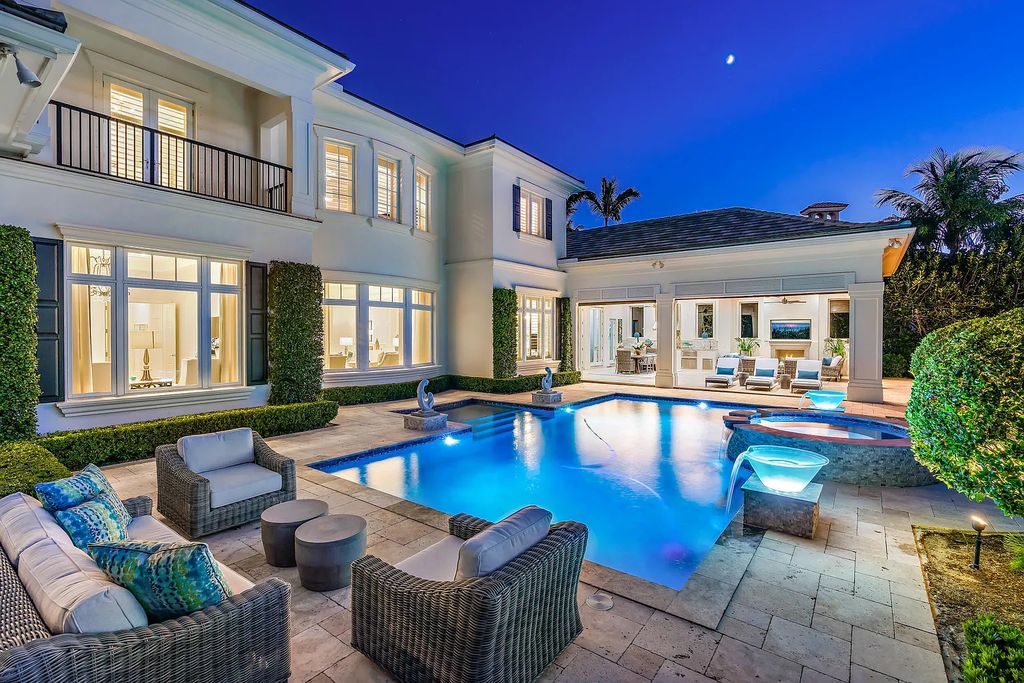 The Estate in Jupiter, a luxurious home on a quiet cul-de-sac street close to The Club features perfect outdoor living space including covered and screen outdoor living room with summer kitchen, fireplace, amazing water view pool is now available for sale. This home located at 109 Schooner Ln, Jupiter, Florida
