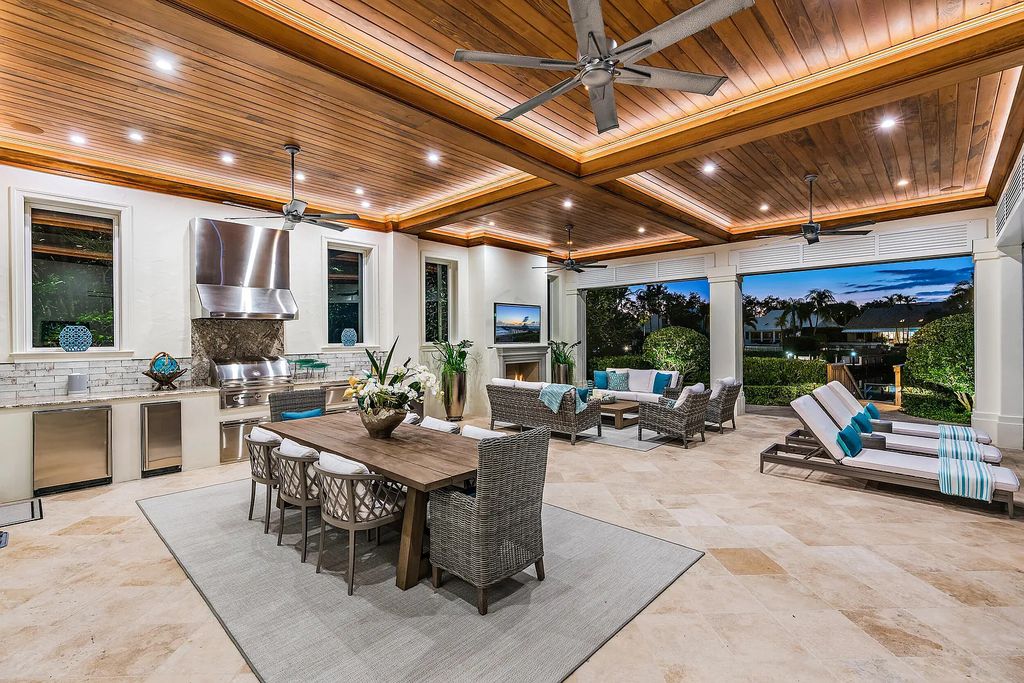 The Estate in Jupiter, a luxurious home on a quiet cul-de-sac street close to The Club features perfect outdoor living space including covered and screen outdoor living room with summer kitchen, fireplace, amazing water view pool is now available for sale. This home located at 109 Schooner Ln, Jupiter, Florida
