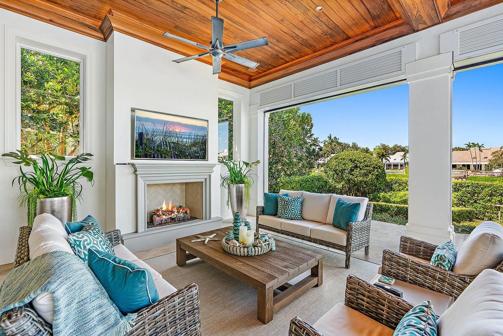 The Estate in Jupiter, a luxurious home on a quiet cul-de-sac street close to The Club features perfect outdoor living space including covered and screen outdoor living room with summer kitchen, fireplace, amazing water view pool is now available for sale. This home located at 109 Schooner Ln, Jupiter, Florida