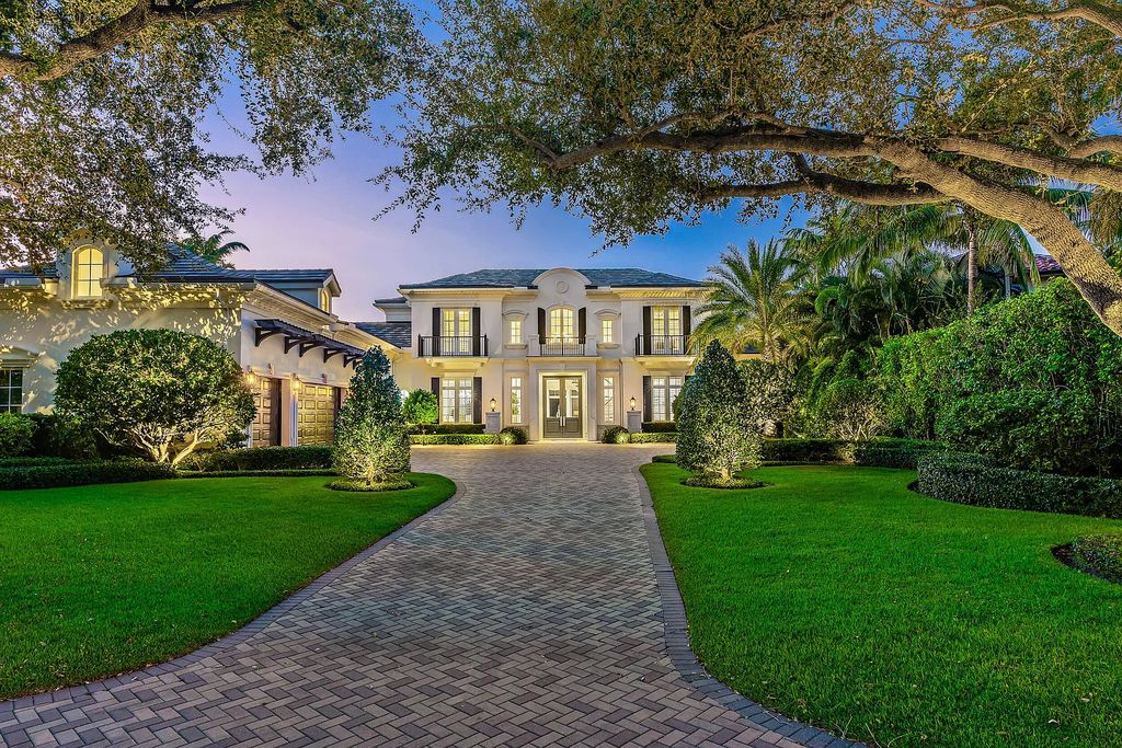The Estate in Jupiter, a luxurious home on a quiet cul-de-sac street close to The Club features perfect outdoor living space including covered and screen outdoor living room with summer kitchen, fireplace, amazing water view pool is now available for sale. This home located at 109 Schooner Ln, Jupiter, Florida