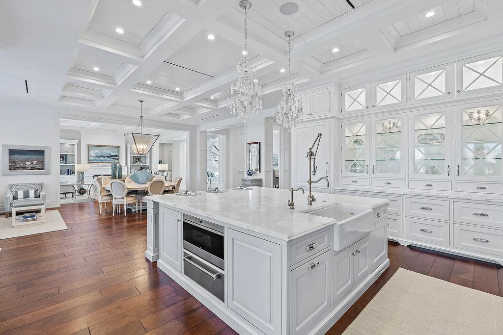 The Estate in Jupiter, a luxurious home on a quiet cul-de-sac street close to The Club features perfect outdoor living space including covered and screen outdoor living room with summer kitchen, fireplace, amazing water view pool is now available for sale. This home located at 109 Schooner Ln, Jupiter, Florida