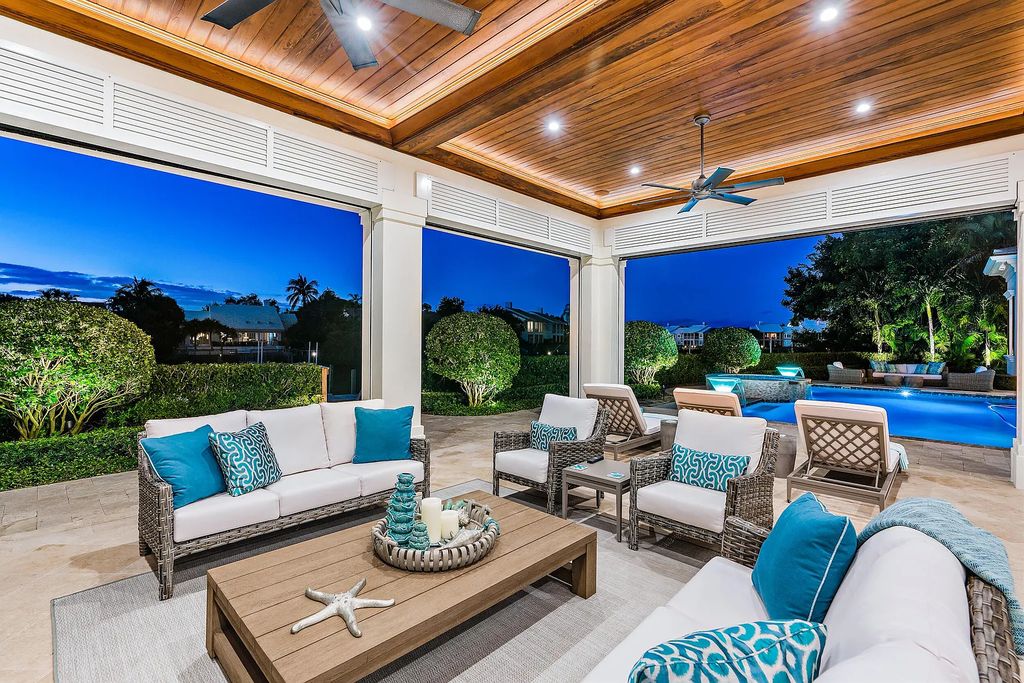 The Estate in Jupiter, a luxurious home on a quiet cul-de-sac street close to The Club features perfect outdoor living space including covered and screen outdoor living room with summer kitchen, fireplace, amazing water view pool is now available for sale. This home located at 109 Schooner Ln, Jupiter, Florida