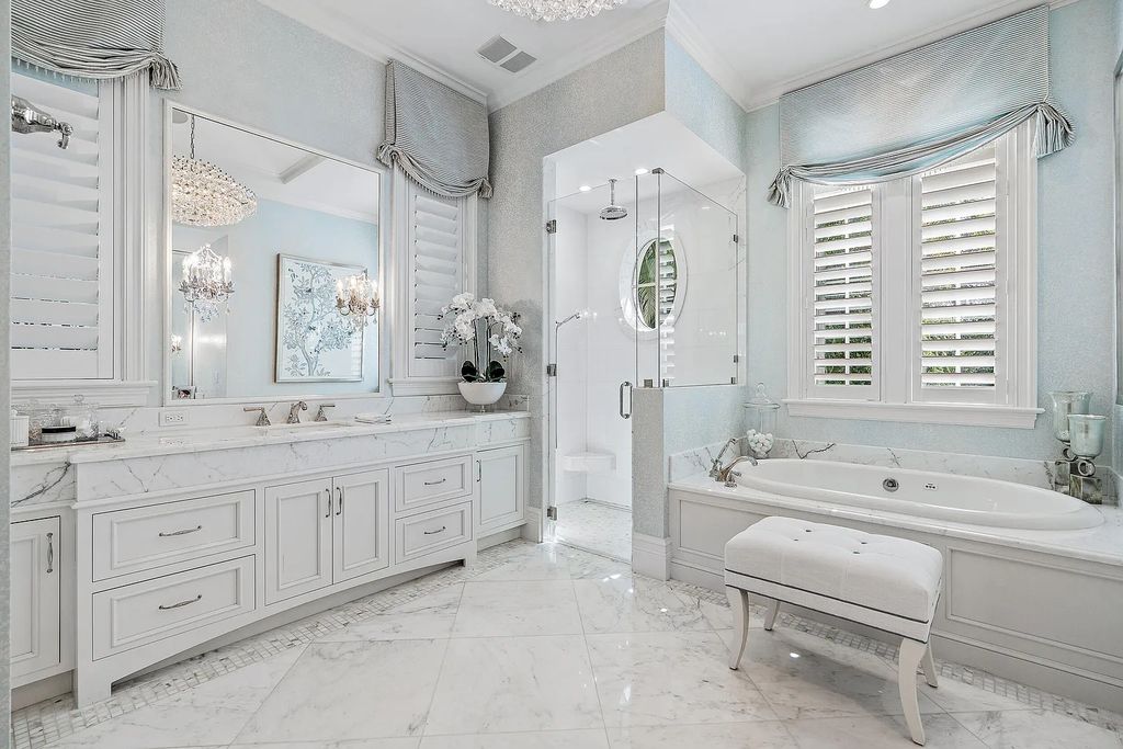 The Estate in Jupiter, a luxurious home on a quiet cul-de-sac street close to The Club features perfect outdoor living space including covered and screen outdoor living room with summer kitchen, fireplace, amazing water view pool is now available for sale. This home located at 109 Schooner Ln, Jupiter, Florida