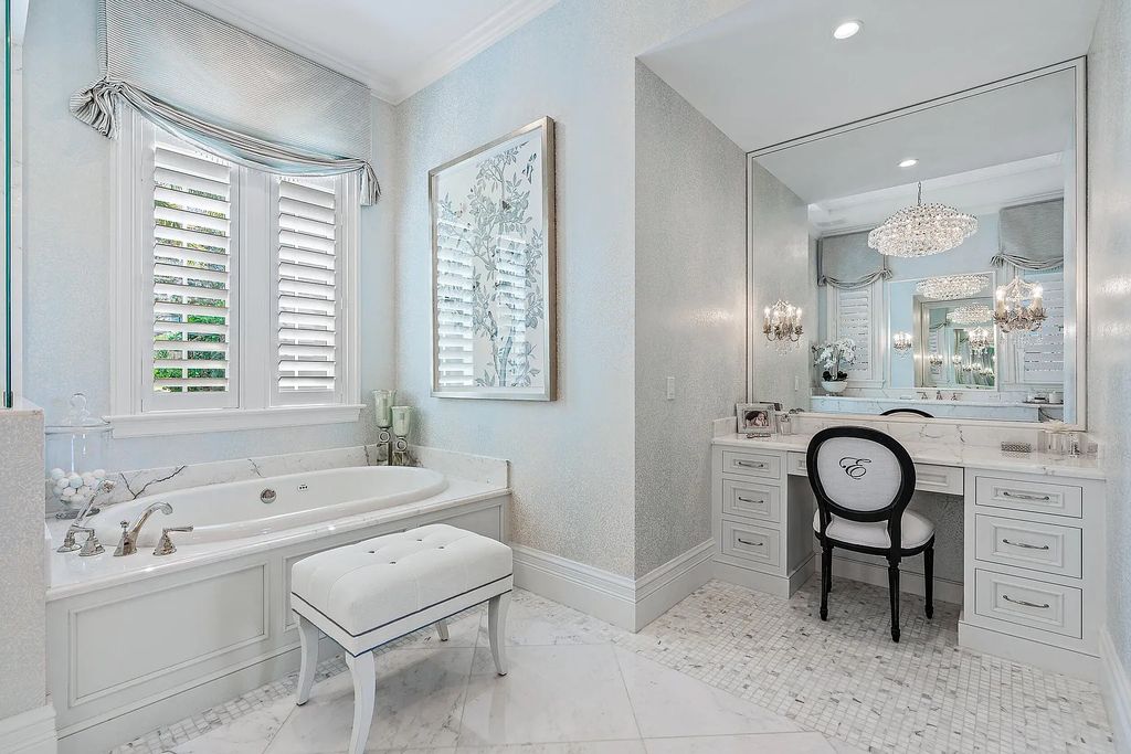 The Estate in Jupiter, a luxurious home on a quiet cul-de-sac street close to The Club features perfect outdoor living space including covered and screen outdoor living room with summer kitchen, fireplace, amazing water view pool is now available for sale. This home located at 109 Schooner Ln, Jupiter, Florida