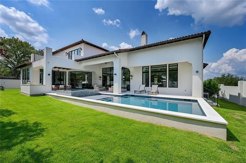 The Home in Austin, an immaculate modern estate nestled in the peaceful and tree-filled neighborhood of Rollingwood features resort-style backyard with a pool and spa, a covered outdoor kitchen is now available for sale. This home located at 4713 Timberline Dr, Austin, Texas