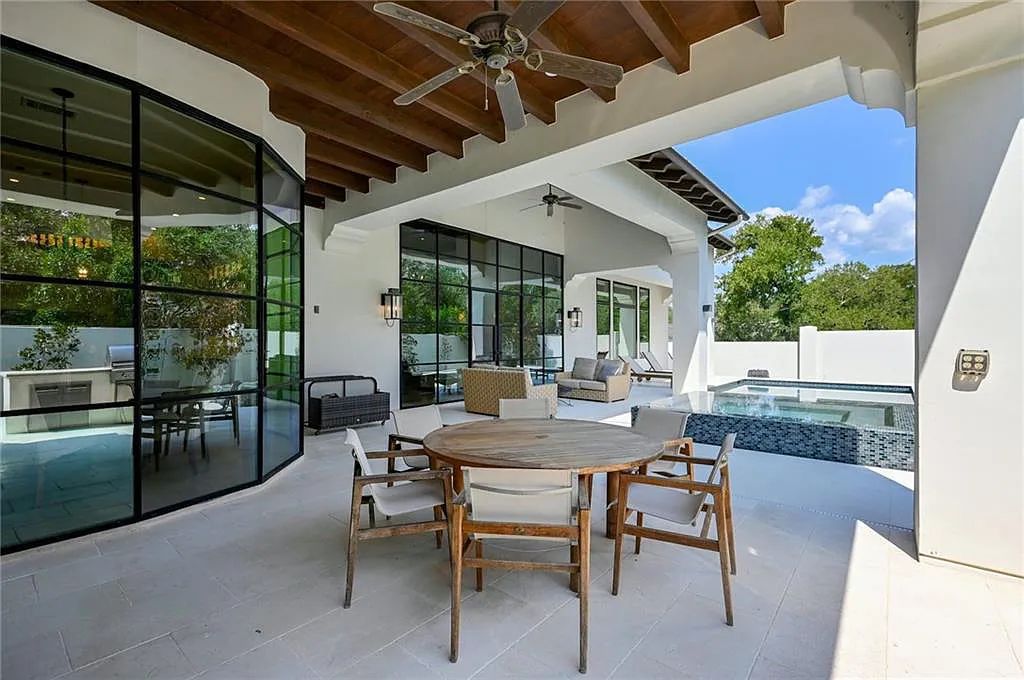 The Home in Austin, an immaculate modern estate nestled in the peaceful and tree-filled neighborhood of Rollingwood features resort-style backyard with a pool and spa, a covered outdoor kitchen is now available for sale. This home located at 4713 Timberline Dr, Austin, Texas