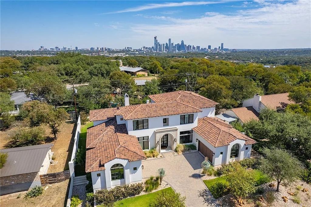 The Home in Austin, an immaculate modern estate nestled in the peaceful and tree-filled neighborhood of Rollingwood features resort-style backyard with a pool and spa, a covered outdoor kitchen is now available for sale. This home located at 4713 Timberline Dr, Austin, Texas