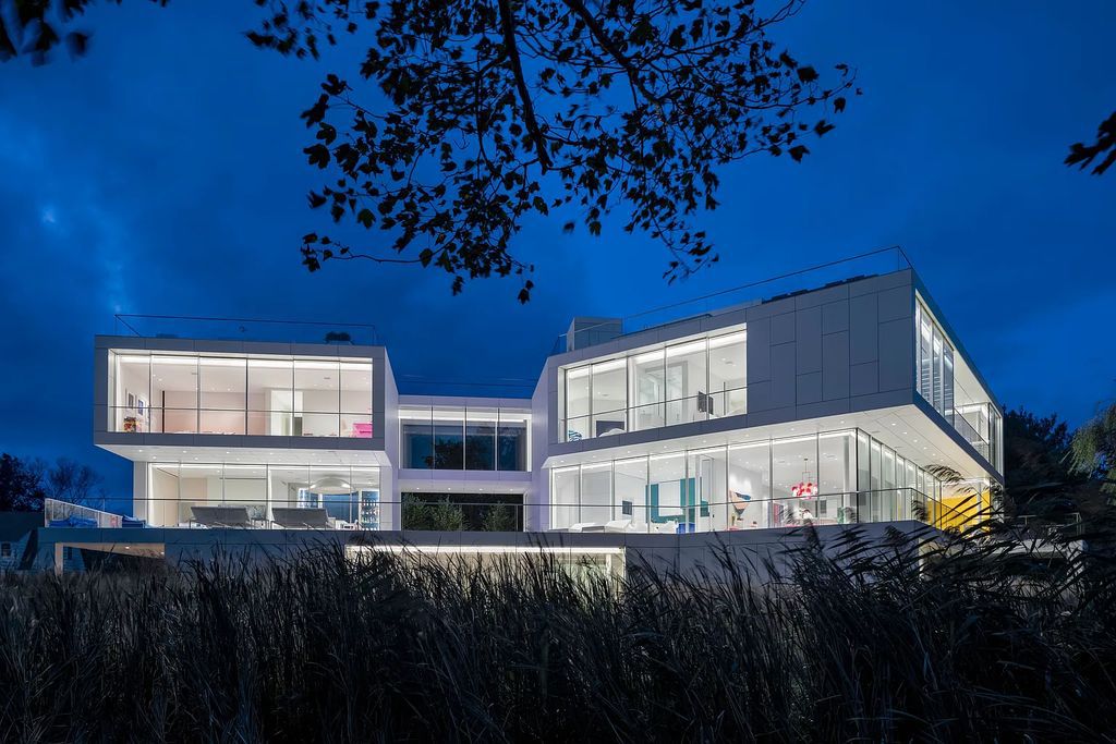 34 Cobb Isle Road, Water Mill, New York is a contemporary architectural masterpiece by renowned architect Roger Ferris overlooking Mecox Bay and the Atlantic Ocean, with 2 docks, plus a fully restored guest house on its own single and separate lot.
