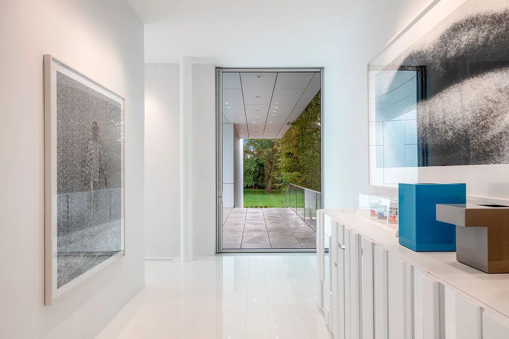 34 Cobb Isle Road, Water Mill, New York is a contemporary architectural masterpiece by renowned architect Roger Ferris overlooking Mecox Bay and the Atlantic Ocean, with 2 docks, plus a fully restored guest house on its own single and separate lot.