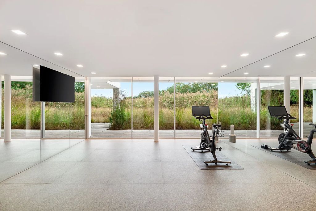 34 Cobb Isle Road, Water Mill, New York is a contemporary architectural masterpiece by renowned architect Roger Ferris overlooking Mecox Bay and the Atlantic Ocean, with 2 docks, plus a fully restored guest house on its own single and separate lot.