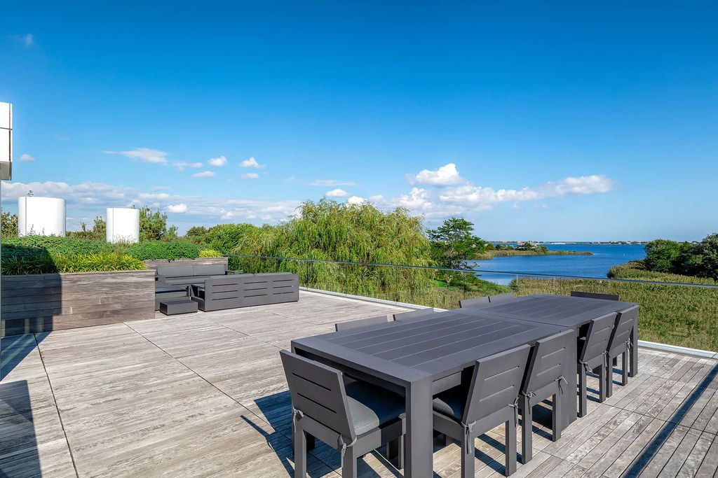 34 Cobb Isle Road, Water Mill, New York is a contemporary architectural masterpiece by renowned architect Roger Ferris overlooking Mecox Bay and the Atlantic Ocean, with 2 docks, plus a fully restored guest house on its own single and separate lot.
