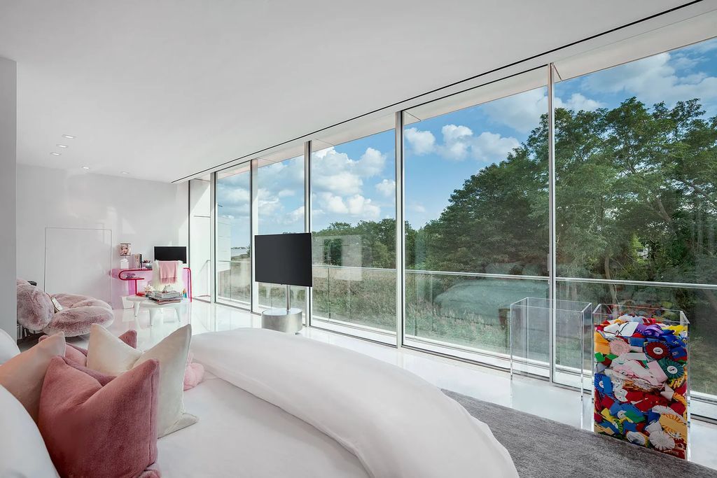 34 Cobb Isle Road, Water Mill, New York is a contemporary architectural masterpiece by renowned architect Roger Ferris overlooking Mecox Bay and the Atlantic Ocean, with 2 docks, plus a fully restored guest house on its own single and separate lot.