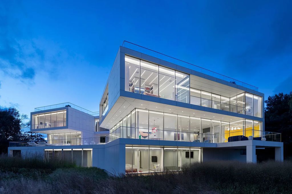 34 Cobb Isle Road, Water Mill, New York is a contemporary architectural masterpiece by renowned architect Roger Ferris overlooking Mecox Bay and the Atlantic Ocean, with 2 docks, plus a fully restored guest house on its own single and separate lot.